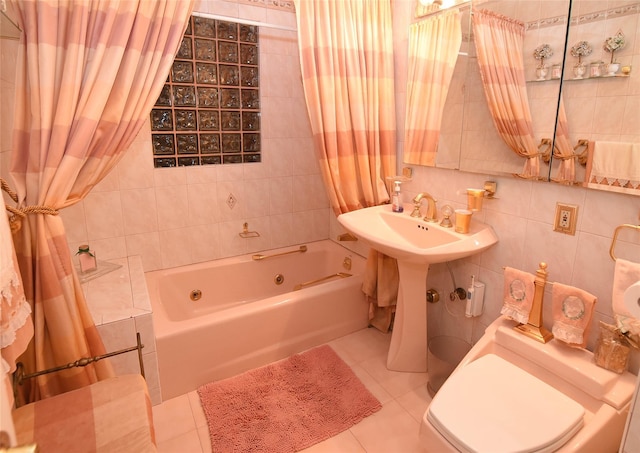 bathroom with tile patterned floors, toilet, tile walls, and washtub / shower combination