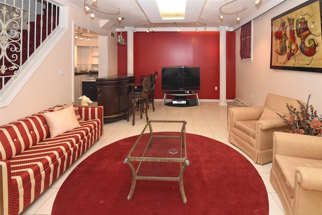 tiled living area with stairs, rail lighting, and baseboards