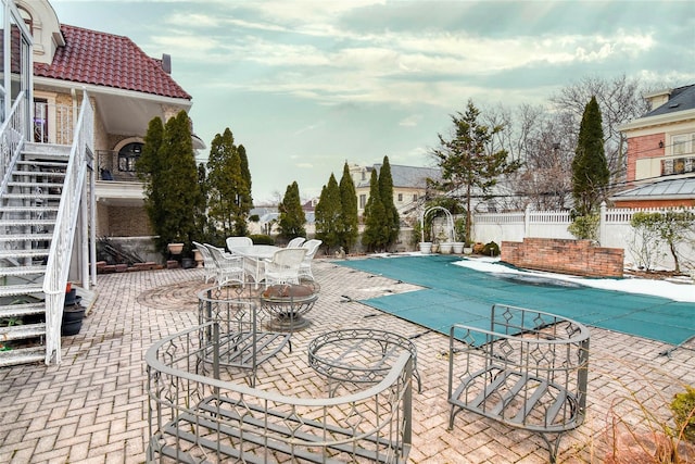 view of pool featuring stairs, a patio, fence, and a fenced in pool