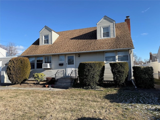 exterior space with a shingled roof, a chimney, cooling unit, and a front yard