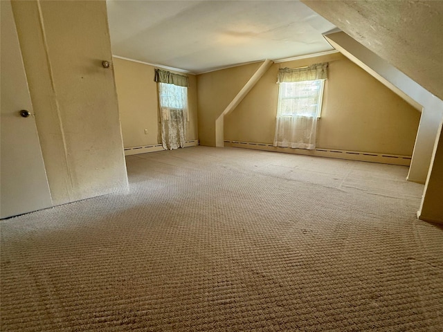 additional living space featuring vaulted ceiling, baseboard heating, and carpet flooring