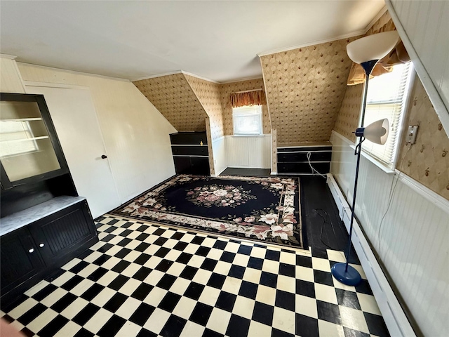 bonus room featuring a baseboard heating unit and wainscoting