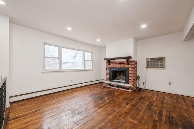 unfurnished living room with hardwood / wood-style flooring, recessed lighting, a fireplace, baseboard heating, and a wall mounted air conditioner