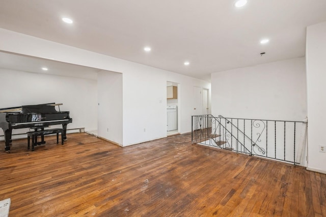 empty room with washer / clothes dryer, recessed lighting, and wood-type flooring