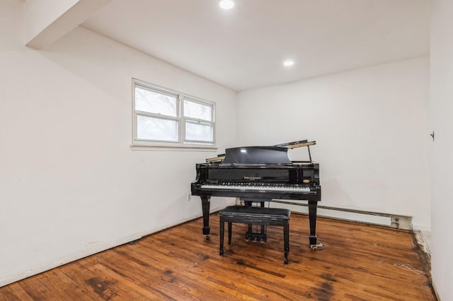 living area with a baseboard radiator, wood finished floors, and recessed lighting