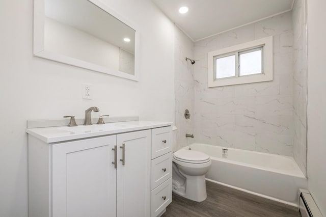 bathroom with shower / bathtub combination, toilet, a baseboard heating unit, vanity, and wood finished floors