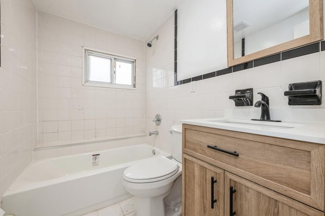 bathroom with tile walls, bathing tub / shower combination, toilet, vanity, and backsplash