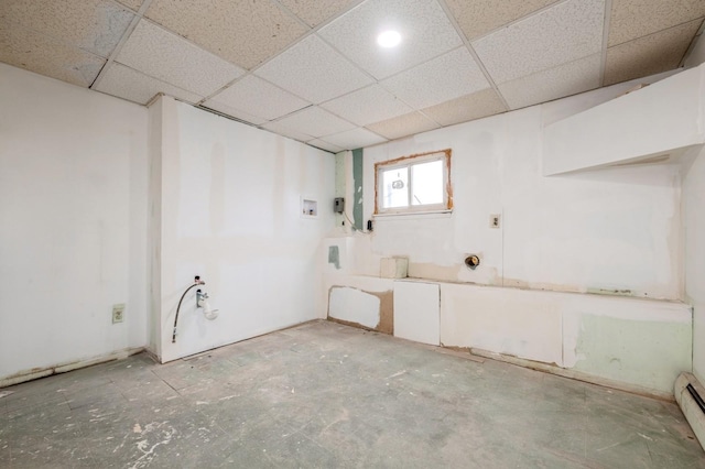 interior space featuring a drop ceiling and baseboard heating