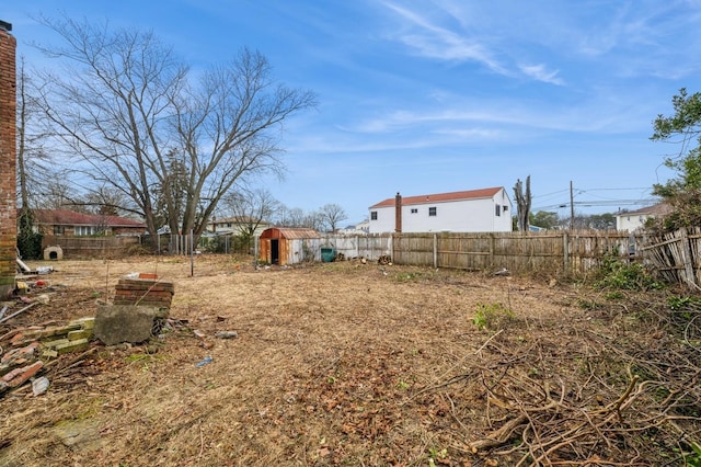 view of yard featuring an outdoor structure and a fenced backyard