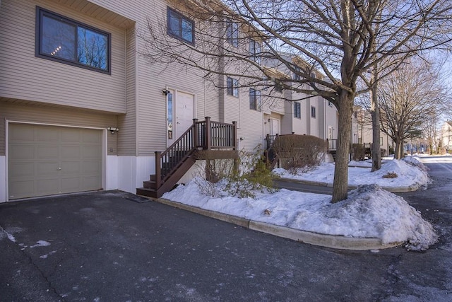 view of front of house featuring a garage, a residential view, and driveway