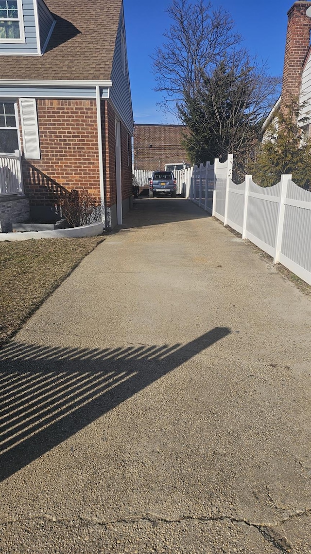 view of parking / parking lot with fence