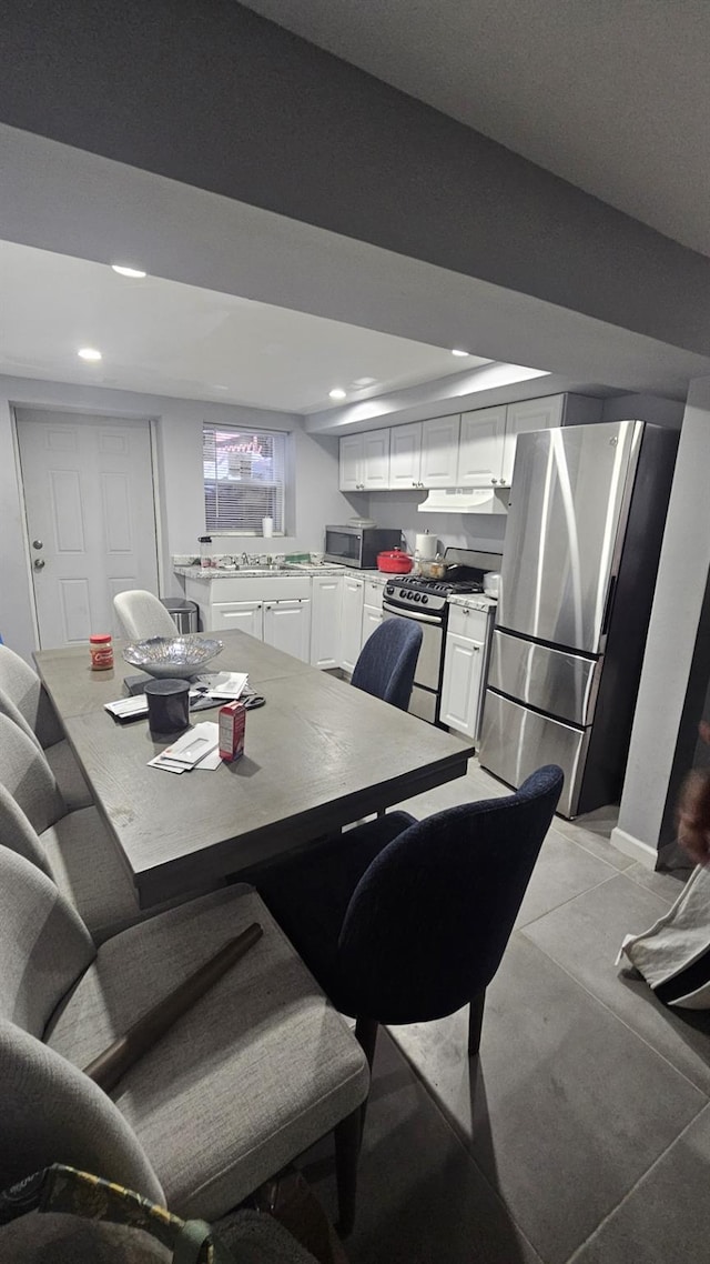 dining space featuring recessed lighting and light tile patterned flooring