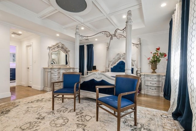 sitting room with ornamental molding, coffered ceiling, light wood finished floors, and ornate columns