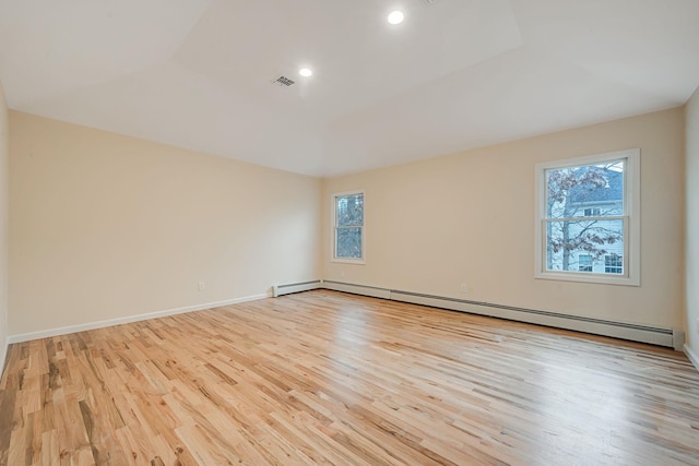 empty room featuring light wood finished floors, baseboards, visible vents, a baseboard radiator, and recessed lighting