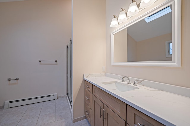 full bathroom with a baseboard heating unit, vanity, baseboards, tile patterned floors, and a stall shower