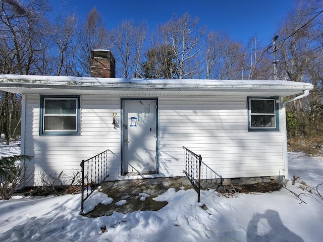 exterior space featuring entry steps and a chimney