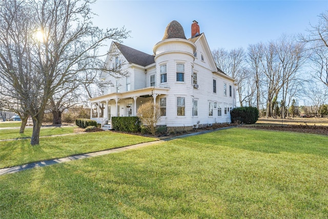 view of front of property with a chimney, a porch, and a front yard