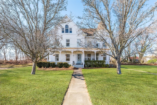 victorian house featuring a porch and a front lawn