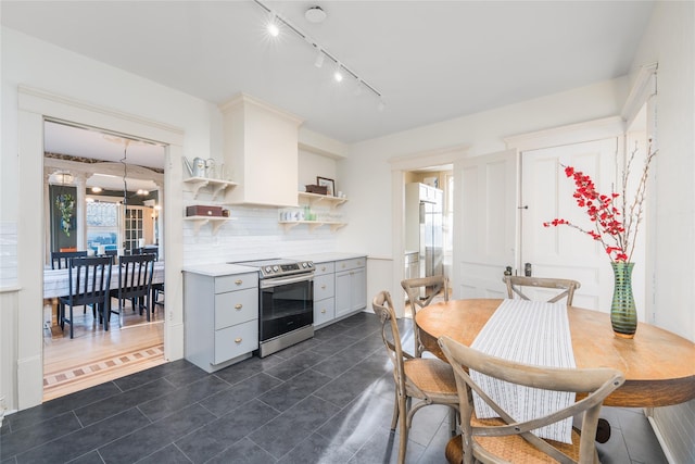 kitchen with plenty of natural light, gray cabinets, light countertops, stainless steel range with electric stovetop, and open shelves