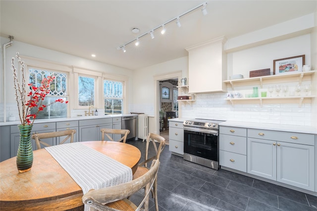 kitchen with open shelves, gray cabinets, light countertops, and stainless steel appliances