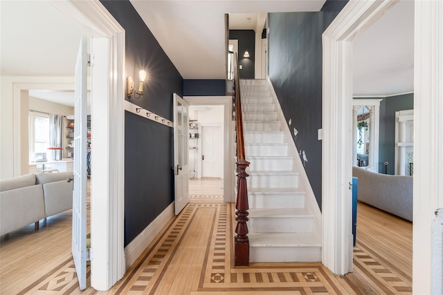 stairs featuring baseboards and wood finished floors