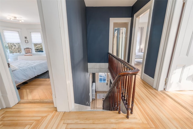 stairway with baseboards and parquet flooring