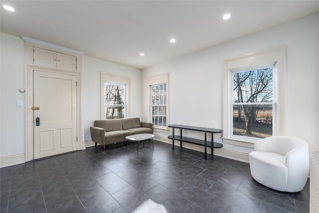 sitting room featuring baseboards, plenty of natural light, and recessed lighting