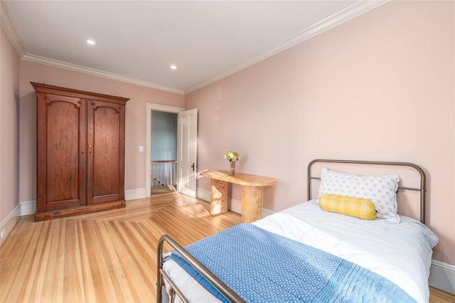 bedroom featuring ornamental molding, recessed lighting, light wood-style floors, and baseboards