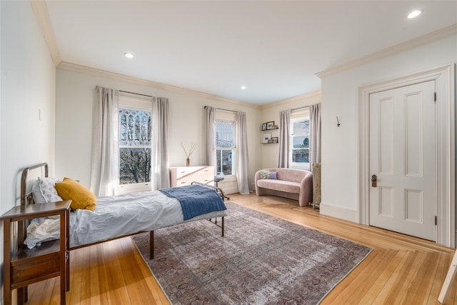 bedroom featuring recessed lighting, crown molding, baseboards, and wood finished floors