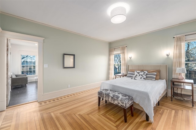 bedroom with ornamental molding and baseboards