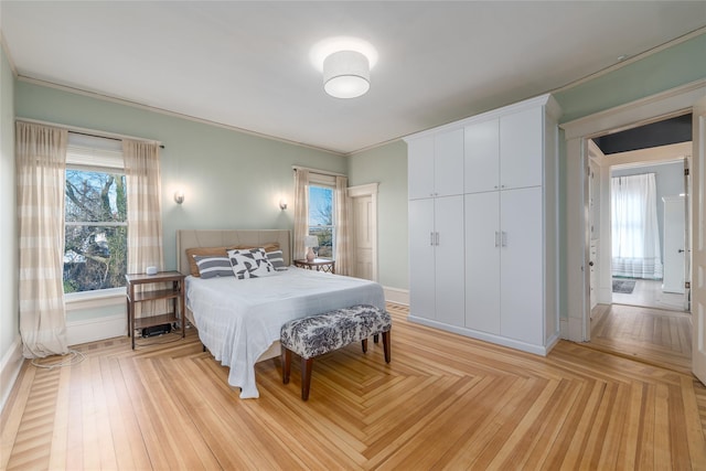 bedroom featuring parquet floors, ornamental molding, and baseboards