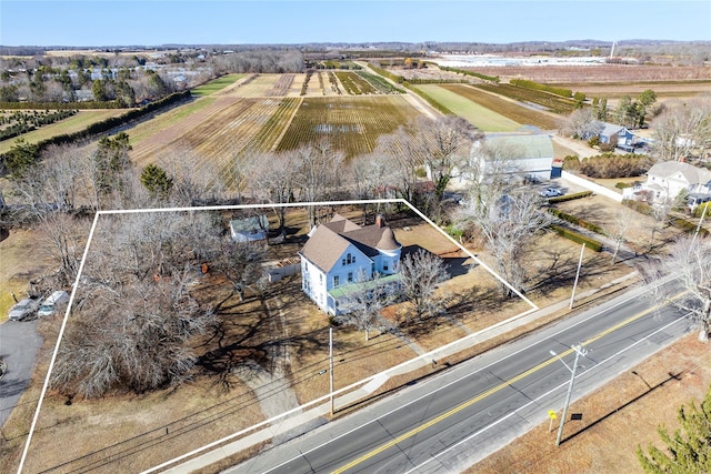 birds eye view of property with a rural view