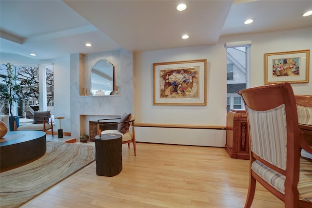 sitting room with light wood finished floors, a fireplace, and recessed lighting