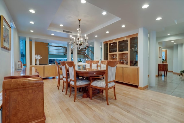 dining room with recessed lighting, a raised ceiling, visible vents, light wood-style floors, and baseboards