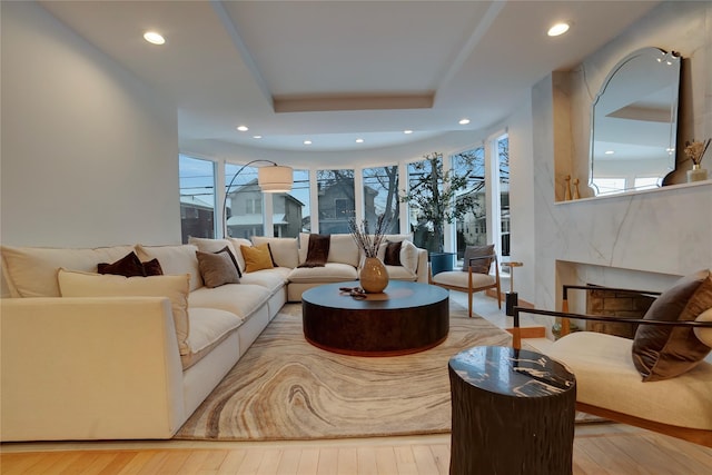 living room with recessed lighting, a fireplace, and hardwood / wood-style floors