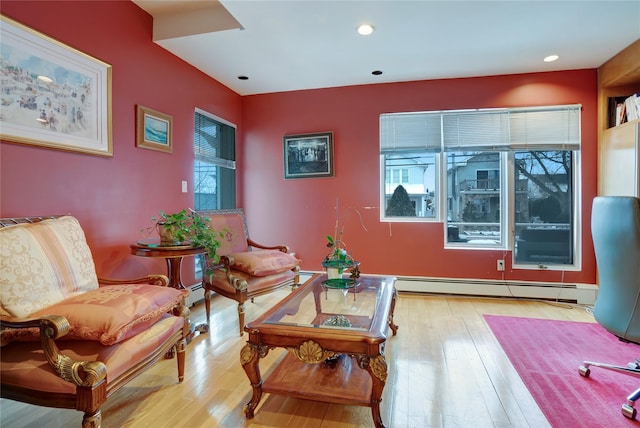 living area with a baseboard radiator, hardwood / wood-style floors, and recessed lighting