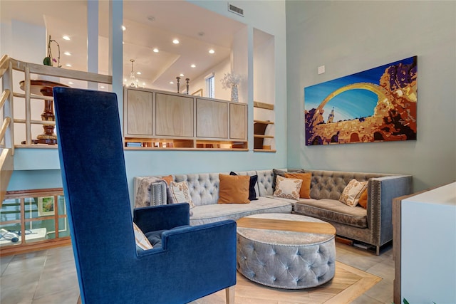 tiled living room featuring recessed lighting, visible vents, and a high ceiling