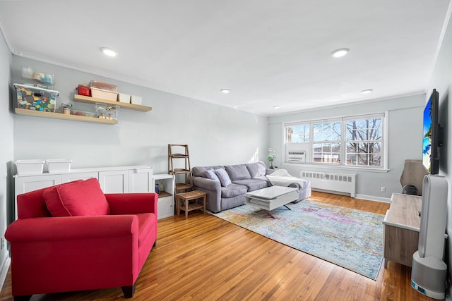 living area with crown molding, light wood-style flooring, radiator heating unit, and recessed lighting