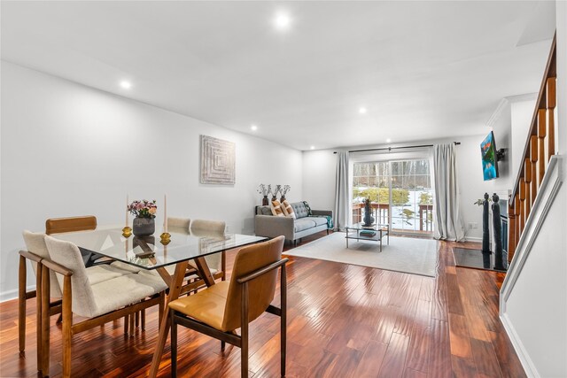 dining room featuring stairs, hardwood / wood-style flooring, recessed lighting, and baseboards