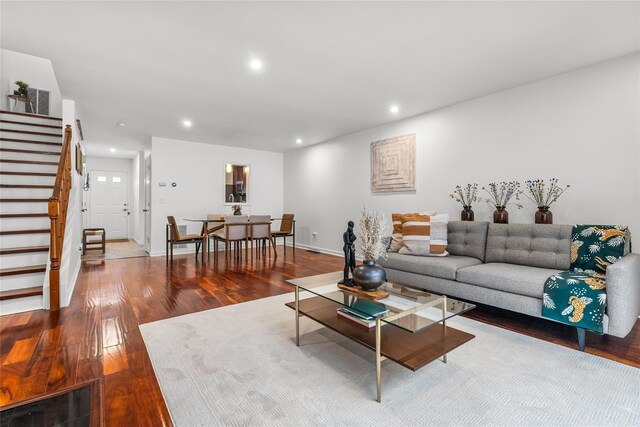 living area featuring recessed lighting, baseboards, stairs, and hardwood / wood-style flooring