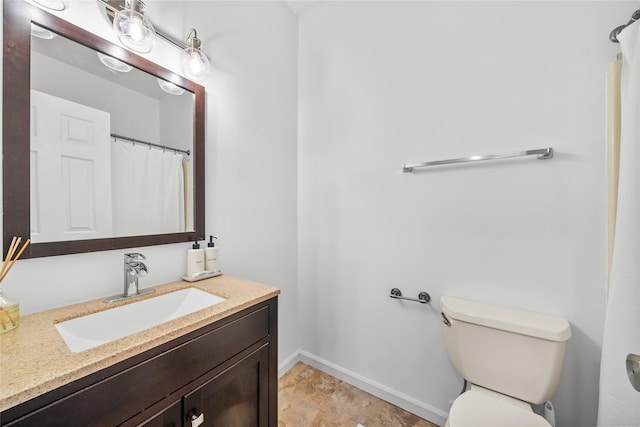 full bath featuring baseboards, toilet, and vanity