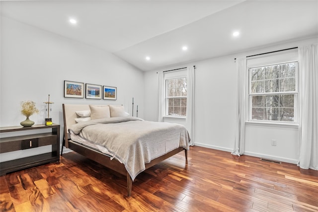 bedroom with visible vents, recessed lighting, lofted ceiling, and wood finished floors