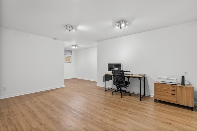 office area with baseboards and light wood-style floors