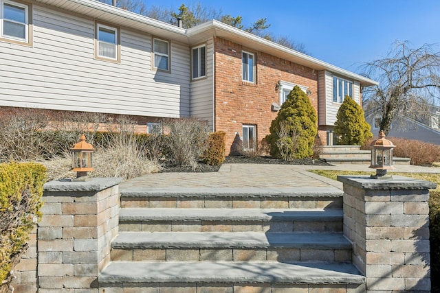 exterior space with brick siding