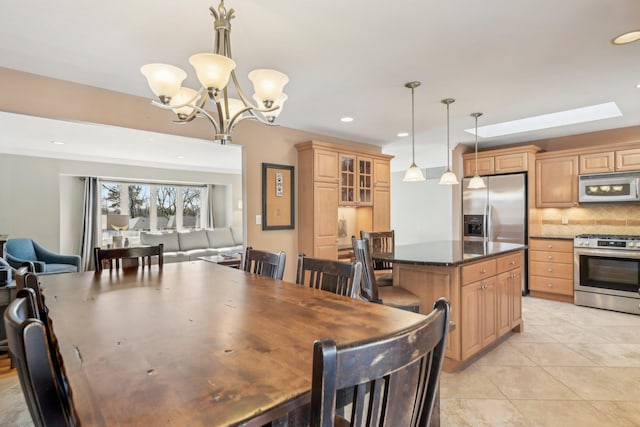 dining area featuring light tile patterned floors, a notable chandelier, and recessed lighting