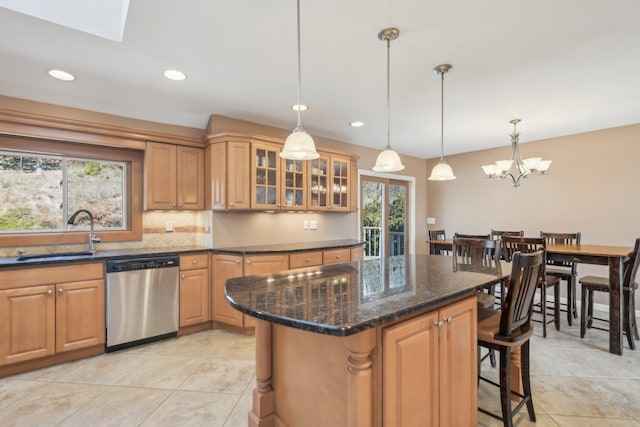 kitchen featuring a sink, decorative backsplash, dishwasher, a kitchen bar, and pendant lighting