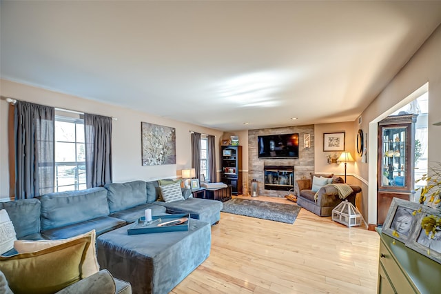 living room with a large fireplace and wood finished floors