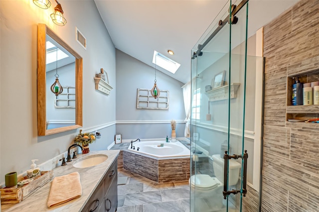 bathroom with a stall shower, visible vents, lofted ceiling with skylight, a garden tub, and vanity