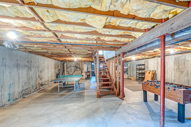 unfinished basement with pool table and stairway