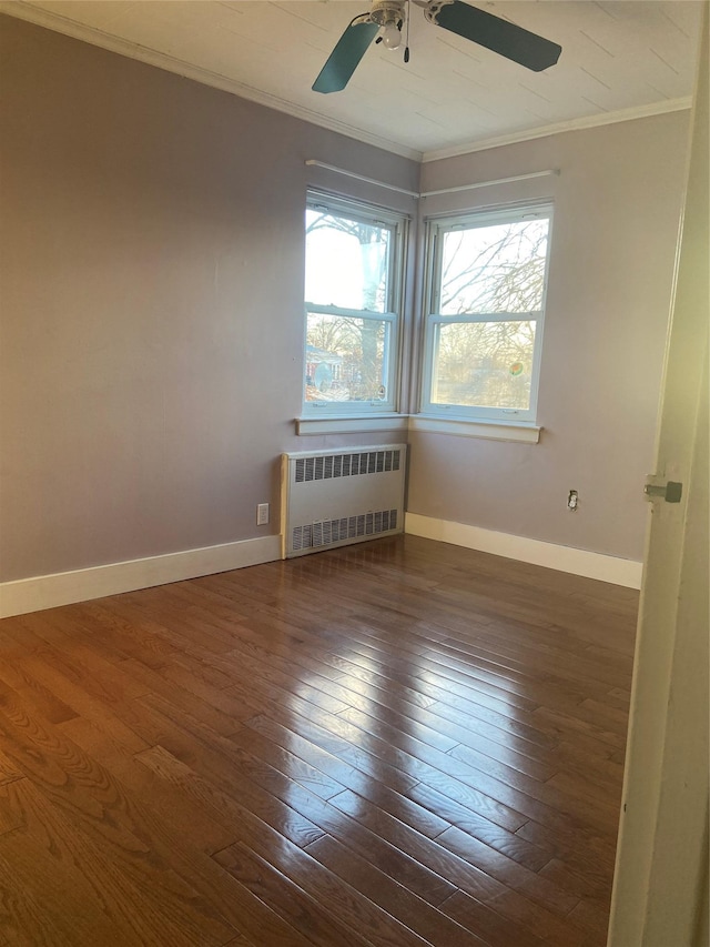 empty room with radiator, baseboards, ornamental molding, and dark wood-style flooring